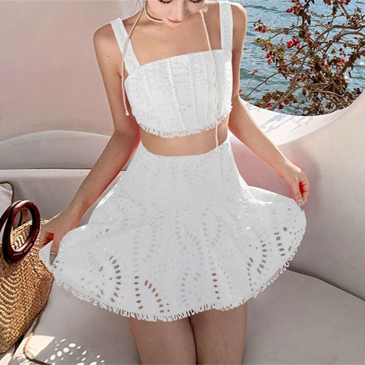 2026 spring and summer women's niche vacation style cotton embroidered hollow vest high waisted skirt set