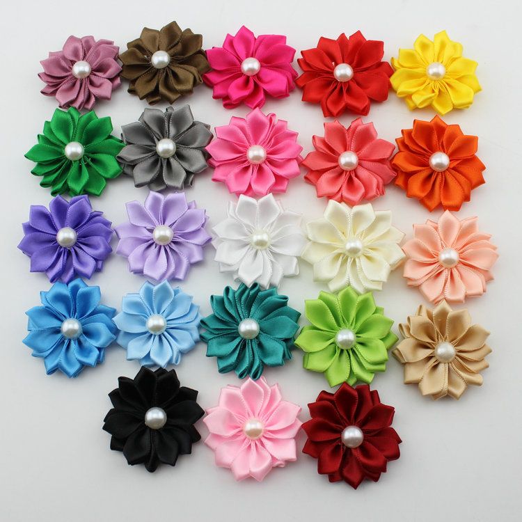 Kanzashi ribbon flower tutorial When given the task of making flower hair clips for our church's Mother Daughter Banquet/Luau, I had a hard time finding single flowers and the thought of making them by hand was overwhelming.