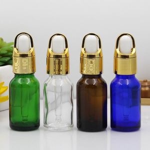 Bouteille d'huile essentielle en verre clair/transparent de 15 ml avec panier en aluminium bouchon compte-gouttes en or brillant LX9454