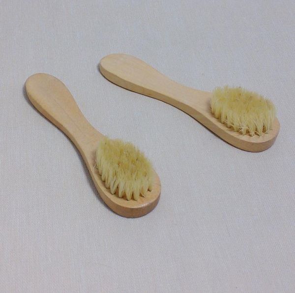 Natural bristle facial brush with wooden handle for gentle exfoliation and dry brushing