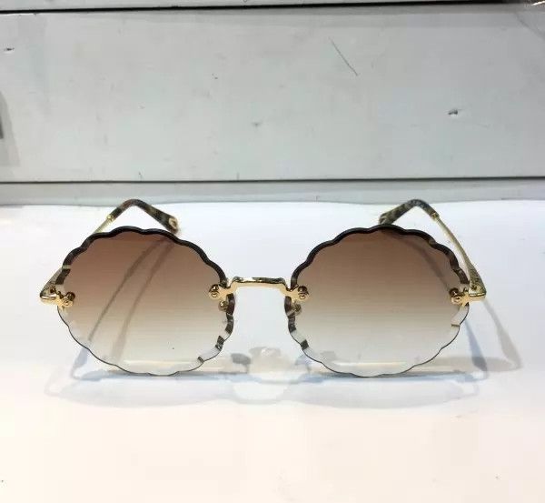 luxury- 142 sunglass for women fashion deisng ce142 round frameless uv400 len summer style adumbral butterfly designer face come with case, White;black 
luxury- 142 sunglass for women fashion deisng ce142 round frameless uv400 len summer style adumbral butterfly designer face come with case, White;black