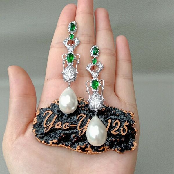 teardrop white sea shell pearl green cz pave insect earrings, Silver
teardrop white sea shell pearl green cz pave insect earrings, Silver