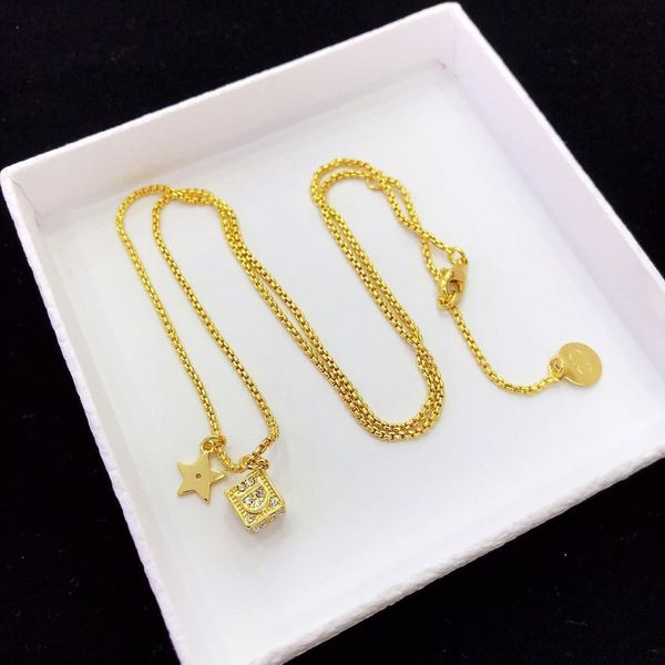 the new line sells dice necklaces a luxurious necklace made of brass and diamond-encrusted lettering