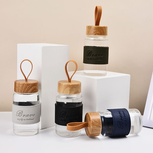 300ml glass drink bottle with wood grain lid cute anti-glass water bottle with leather sheath
300ml glass drink bottle with wood grain lid cute anti-glass water bottle with leather sheath