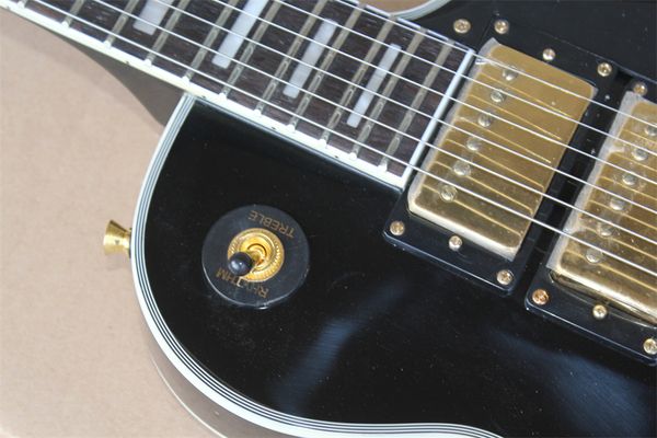 black electric guitar, rosewood fingerboard, yellow binding, 3 pickups, tremolo system electric guitar
black electric guitar, rosewood fingerboard, yellow binding, 3 pickups, tremolo system electric guitar