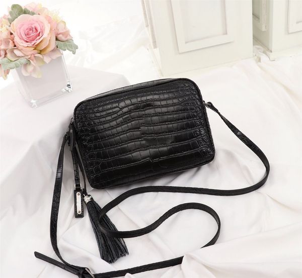 a seller in a one-shouldered calfskin crocodile camera bag with riding crop tassel pendant
a seller in a one-shouldered calfskin crocodile camera bag with riding crop tassel pendant
