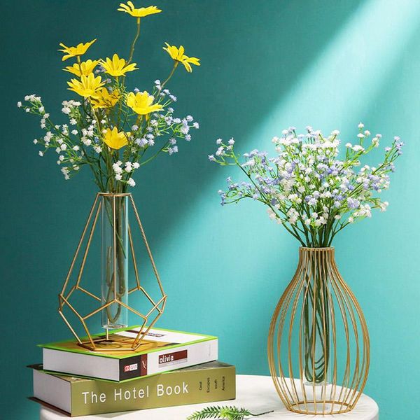vases small transparent wrought iron vase on the dining table, golden metal glass vase, flower arrangement in living room
vases small transparent wrought iron vase on the dining table, golden metal glass vase, flower arrangement in living room