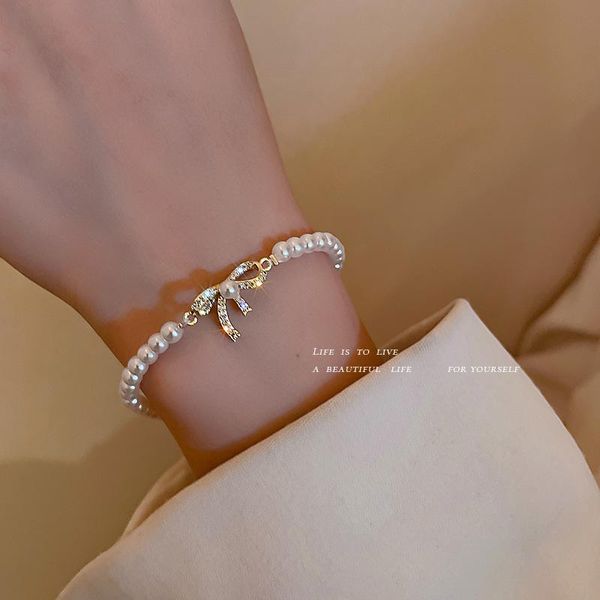 link, chain pure gold plated baroque bow pearl bracelet with a niche design feel, Black
link, chain pure gold plated baroque bow pearl bracelet with a niche design feel, Black