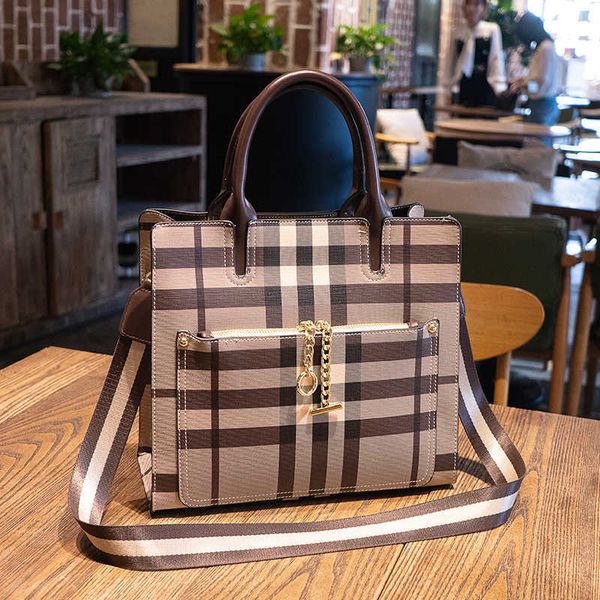 2021 check women's bag wide shoulder belt official document tote large capacity portable temperament goddess one shoulder messenger bag
2021 check women's bag wide shoulder belt official document tote large capacity portable temperament goddess one shoulder messenger bag