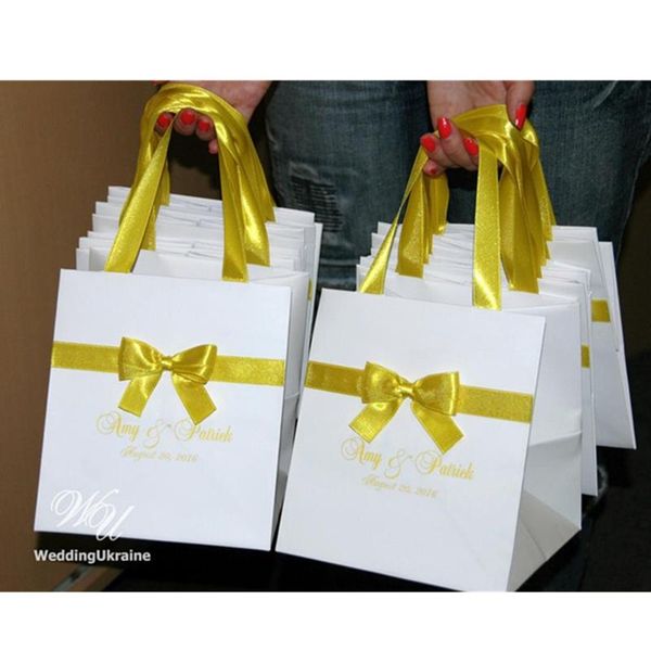 gift wrap personalized yellow wedding welcome bags with satin ribbon, bow and names - white paper for favors
gift wrap personalized yellow wedding welcome bags with satin ribbon, bow and names - white paper for favors