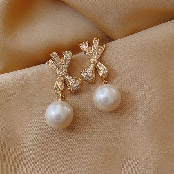 elegant womens bow earrings pearl pendant silver pin with cubic zircon, Golden
elegant womens bow earrings pearl pendant silver pin with cubic zircon, Golden