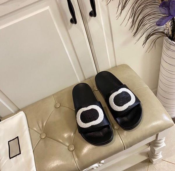 flat cowhide slippers: designer logo, wool-lined & luxe - ideal for beach or home, Black
flat cowhide slippers: designer logo, wool-lined & luxe - ideal for beach or home, Black