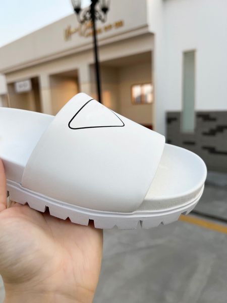 2022 designer leather slippers with rubber spiked soles and screen printed triangular logo black and white sandals
2022 designer leather slippers with rubber spiked soles and screen printed triangular logo black and white sandals