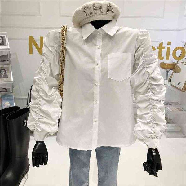 bubble sleeve plied pearl white shirt button 2021 niche spring temperament retro design
bubble sleeve plied pearl white shirt button 2021 niche spring temperament retro design