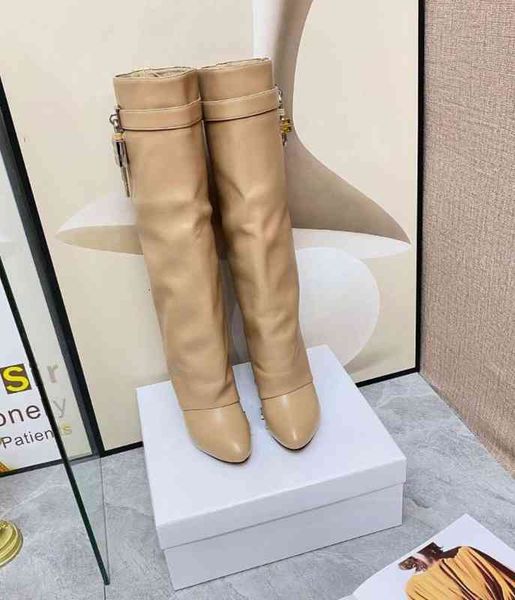 lock knee shark boots leather silver and gold finish asymmetrical metal padlock clad wedge almond shaped toe heel height 9cm, Black
lock knee shark boots leather silver and gold finish asymmetrical metal padlock clad wedge almond shaped toe heel height 9cm, Black
