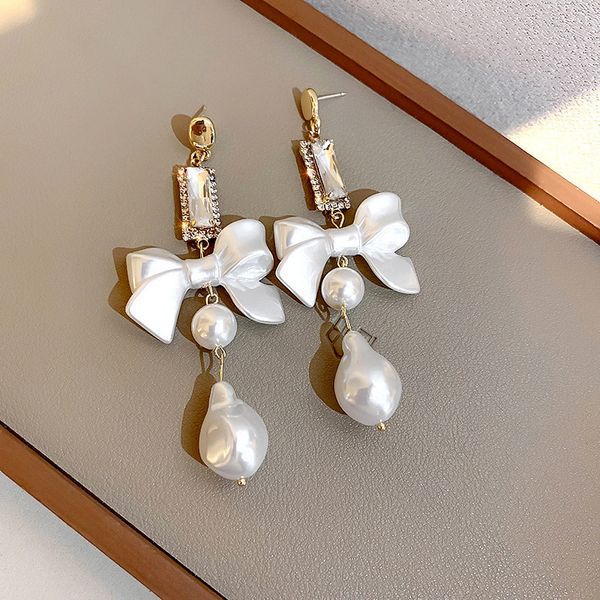 925 silver needle korean style pearl diamond bow earrings sweet design net red fashion eardrop, Golden
925 silver needle korean style pearl diamond bow earrings sweet design net red fashion eardrop, Golden