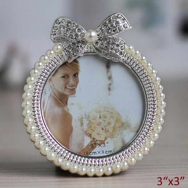 frames cute small circle with ribbon design silver plating white pearls and clear crystal jeweled metal table po frame 3 inches
frames cute small circle with ribbon design silver plating white pearls and clear crystal jeweled metal table po frame 3 inches