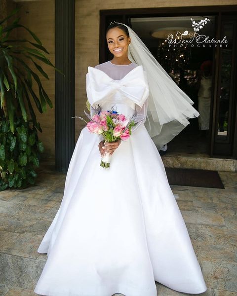 illusion o-neck white african wedding dresses sheer tulle long sleeve wedding gowns simple satin with big bow front country bride dresses
illusion o-neck white african wedding dresses sheer tulle long sleeve wedding gowns simple satin with big bow front country bride dresses