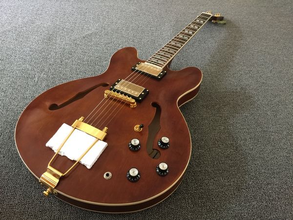 electric guitar hollow body brown see thru wood grain gold parts.