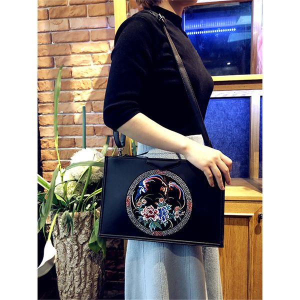 a woman holds a bag embroidered soft leather multi-function envelopes thin handbag woman round one shoulder hand bag
a woman holds a bag embroidered soft leather multi-function envelopes thin handbag woman round one shoulder hand bag