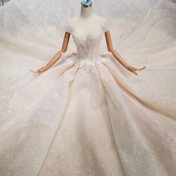 Special wedding dre cry tal cap leeve illu ion o neck handmade beaded wedding gown ee through open back new fa hion de ign 
Special wedding dre cry tal cap leeve illu ion o neck handmade beaded wedding gown ee through open back new fa hion de ign