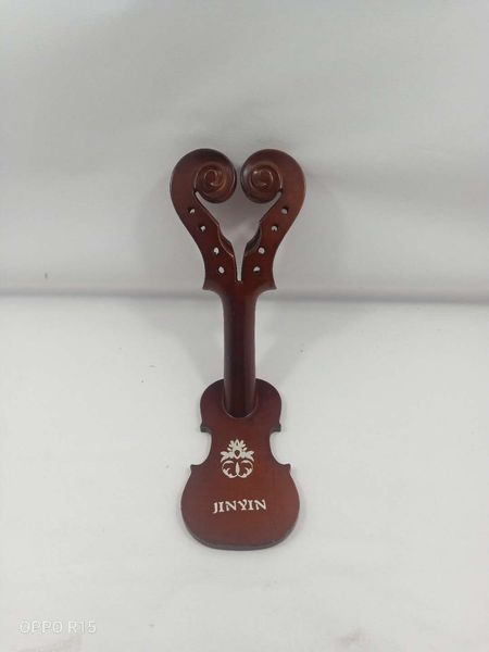 violin wine holder with double head carved from rich wood 
violin wine holder with double head carved from rich wood