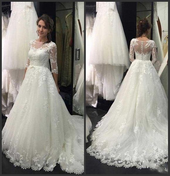 Elegant Lace A-Line Wedding Dresses with 3/4 Sleeves vestido de noiva Sheer Neck Modest Bridal Dress Country Wedding Gowns with Buttons 
Elegant Lace A-Line Wedding Dresses with 3/4 Sleeves vestido de noiva Sheer Neck Modest Bridal Dress Country Wedding Gowns with Buttons