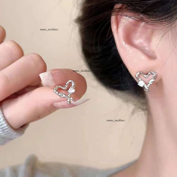Exquisite and versatile hollow heart-shaped zircon for women, summer trendy earrings with a unique design, popular online