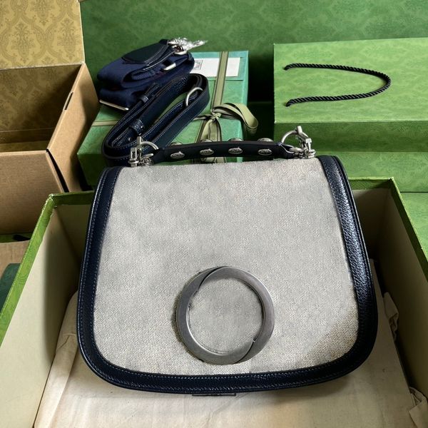 designer medium bag geometrically shaped with one studded handle one canvas strap and a leather strap crossbody bag
designer medium bag geometrically shaped with one studded handle one canvas strap and a leather strap crossbody bag