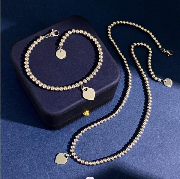 new designed fashion 925 silver t-letter peach heart gold beads chain necklace titanium steel love beads chain bracelet designer jewelry t08
new designed fashion 925 silver t-letter peach heart gold beads chain necklace titanium steel love beads chain bracelet designer jewelry t08