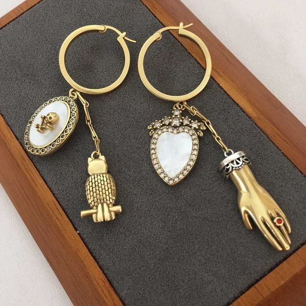 fashion designer alexander queen white shell owl ghost hand asymmetric earrings female personality love skull head with diamond earrings, Golden
fashion designer alexander queen white shell owl ghost hand asymmetric earrings female personality love skull head with diamond earrings, Golden