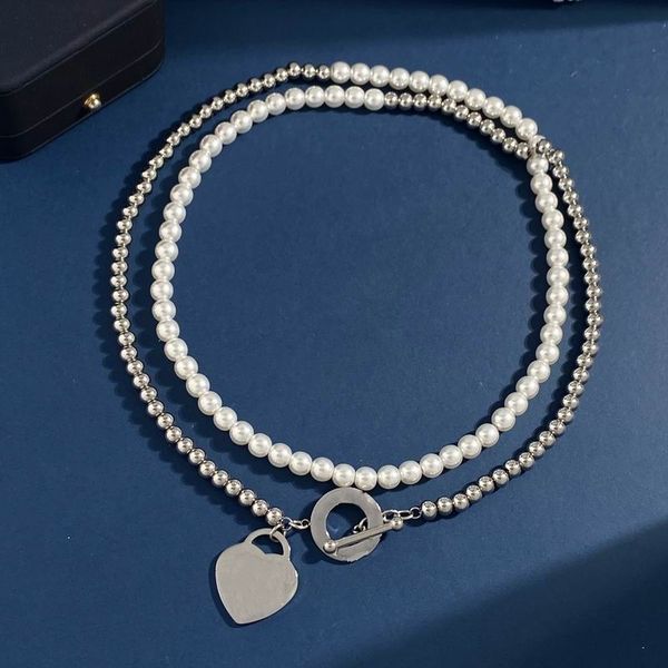 2023 lovely cute pendant necklaces long silver pearl beads heart ring pendant design women necklace with dust bag and box
2023 lovely cute pendant necklaces long silver pearl beads heart ring pendant design women necklace with dust bag and box