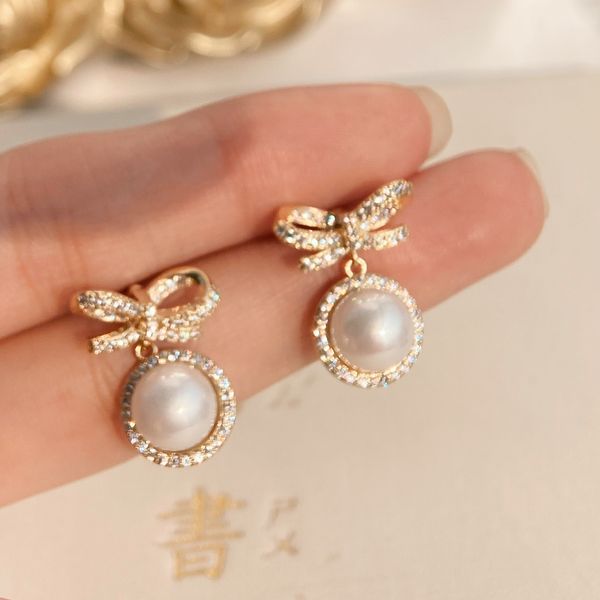 s3671 gold plated bowknot pearl dangle earrings for women s925 silver needle zircon stud earrings
s3671 gold plated bowknot pearl dangle earrings for women s925 silver needle zircon stud earrings