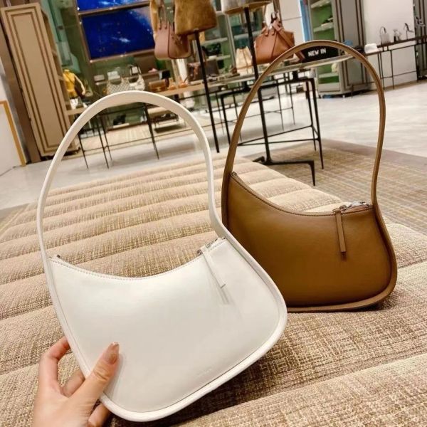 the row half moon bag in smooth leather women designer with flat shoulder strap and curved zipper closure clutch tote suded lining underarm
the row half moon bag in smooth leather women designer with flat shoulder strap and curved zipper closure clutch tote suded lining underarm