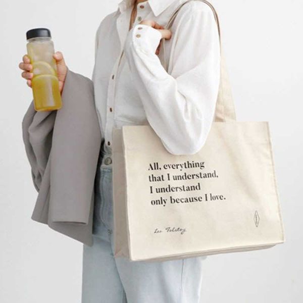 a homemade classic niche blue letter shoulder bag beige large cloth bag french canvas bag
a homemade classic niche blue letter shoulder bag beige large cloth bag french canvas bag