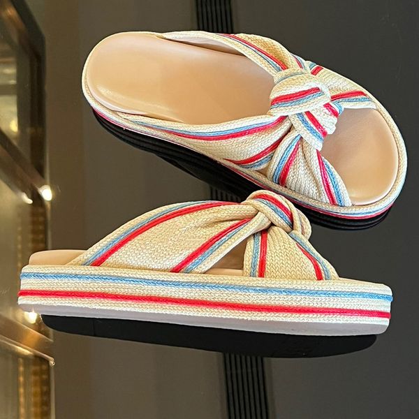 pale yellow raffia slides color beige flat sides with knotted band made of pale yellow braided raffia light blue and red embroidered details, Black
pale yellow raffia slides color beige flat sides with knotted band made of pale yellow braided raffia light blue and red embroidered details, Black