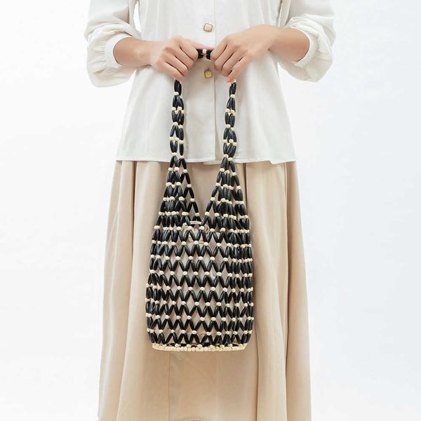 woven bag for women's summer niche design hollow out wooden bead bag portable bucket shoulder bag 230718
woven bag for women's summer niche design hollow out wooden bead bag portable bucket shoulder bag 230718