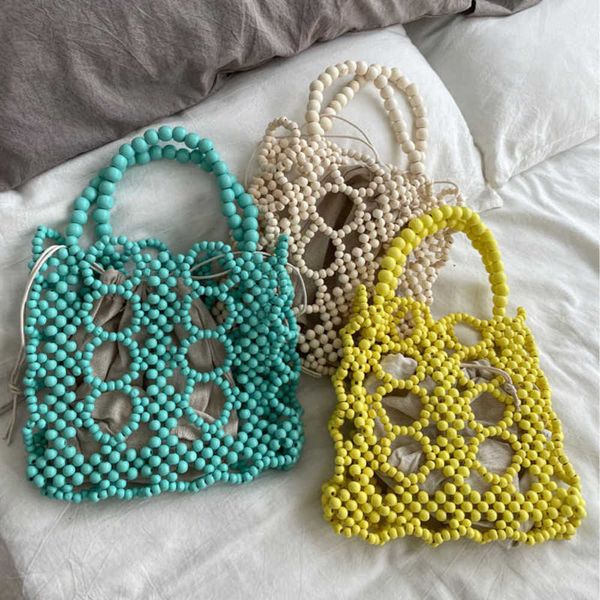 fashion wooden beading women handbags designer hollow small tote luxury lady handbags summer beach bag bali shopper purses 2022 230412
fashion wooden beading women handbags designer hollow small tote luxury lady handbags summer beach bag bali shopper purses 2022 230412