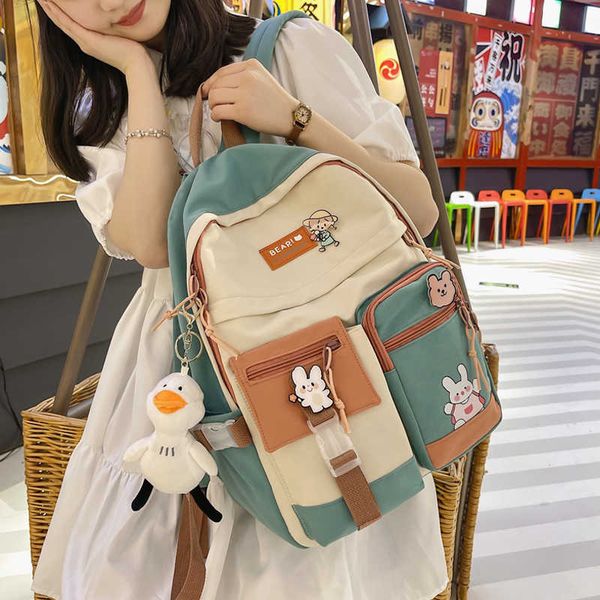 

2023 new badge buckle backpack women waterproof color patchwork backpacks for teenage girl school bag fancy student book 230223