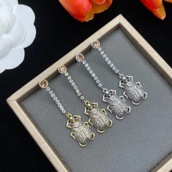 skull pendants full of drill insects luxury designer earrings, Golden 
skull pendants full of drill insects luxury designer earrings, Golden