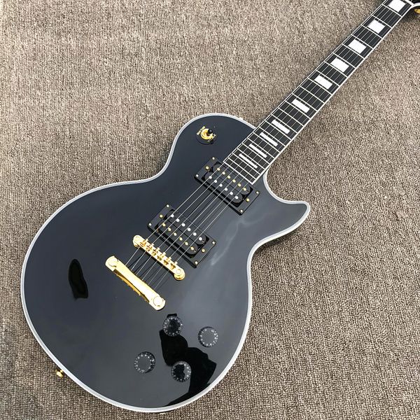 custom shop, caston black electric guitar with grooves at the back of the body, ebony fingerboard, gold hardware, ing
custom shop, caston black electric guitar with grooves at the back of the body, ebony fingerboard, gold hardware, ing