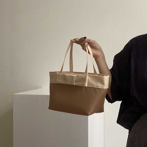 new contrast bow small handbag with rice bag picnic bag nylon oxford fabric bag handbag
new contrast bow small handbag with rice bag picnic bag nylon oxford fabric bag handbag