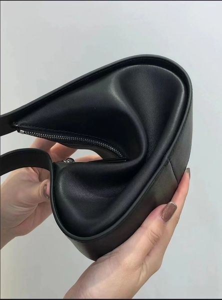 the row bag new half moon bag in smooth leather women designer with flat shoulder strap and curved zipper closure clutch tote suded lining u
the row bag new half moon bag in smooth leather women designer with flat shoulder strap and curved zipper closure clutch tote suded lining u