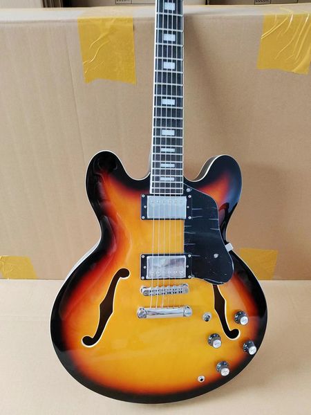 Semi-Hollow Sunburst Guitar - Black/Orange Fade, Metallic Pickups & F-Hole Resonance
Semi-Hollow Sunburst Guitar - Black/Orange Fade, Metallic Pickups & F-Hole Resonance