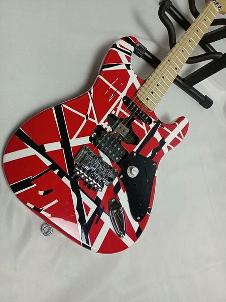 Vibrant Red Double-Cutaway Guitar: Bold Geometric Design, Tremolo Bridge & Multiple Pickups
Vibrant Red Double-Cutaway Guitar: Bold Geometric Design, Tremolo Bridge & Multiple Pickups