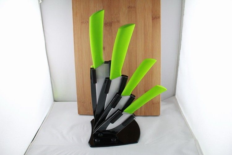  kitchen knives, green handle white blade with acrylic knife block