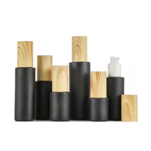 Flacons à pompe en verre vides rechargeables bouteilles de lotion en verre dépoli noir flacon pulvérisateur d'huile essentielle avec bouchon en plastique grain de bois 20 ml - 80 m Kgwx