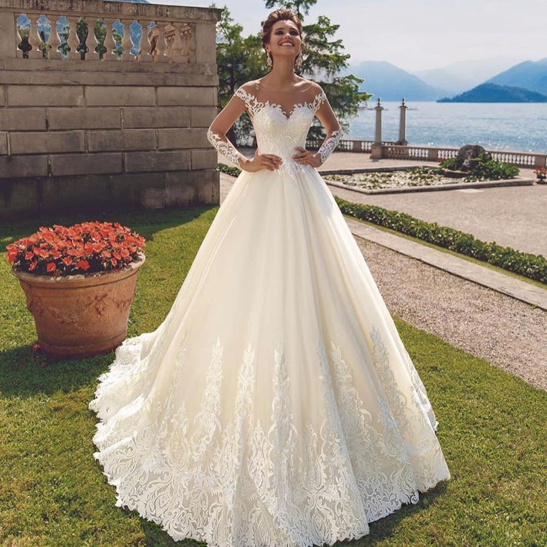 A Line Amazing Long Sleeves Lace Wedding Dresses Sheer Bateau Neck Covered Buttons Back Bridal Gowns Tulle Sweep Train Robe De Marie