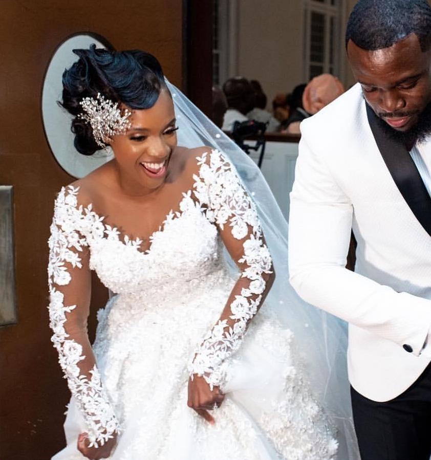 Charming African Floral Lace Appliquéd Ivory Wedding Dress for Bride with Beads & Long Sleeves  Ethereal Chapel Trail Veil