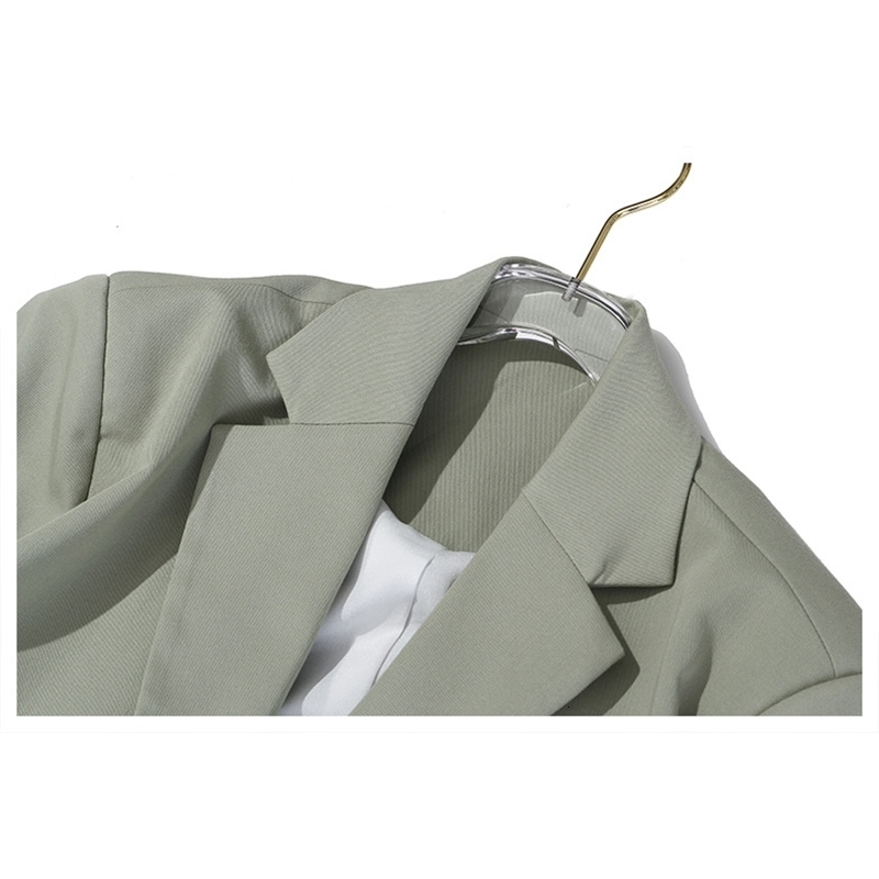 [EAM] Women Asymmetrical Hollow Out Long Trench New Lapel Long Sleeve Loose Fit Windbreaker Fashion Spring Autumn LJ201128